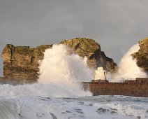 Portreath 2 Waves splashes away from the monkey hut on Portreath pier with some evening sunshine.